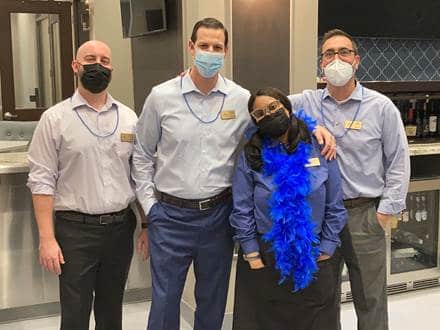 4 people dressed in blue for fight against cancer